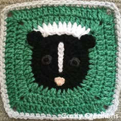 a crocheted square with a bear's head on it