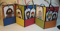 four small gift bags decorated with cartoon characters on them and tied to the handles, all in different colors