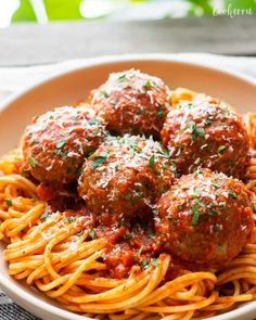 spaghetti with meatballs and sauce in a bowl