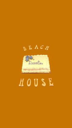 a cake that is sitting on top of a table with the words beach house written across it