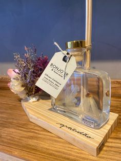 a bottle of perfume sitting on top of a wooden table