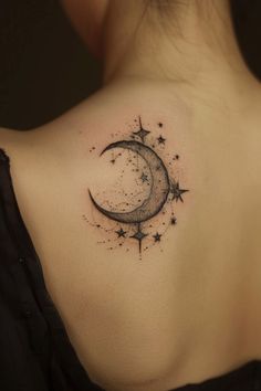 a woman's back shoulder with a crescent and stars tattoo