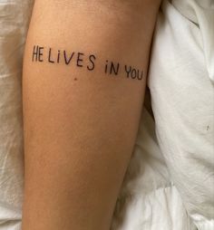 someone has written on their leg that says, he lives in you