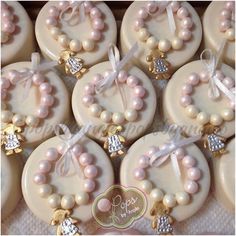 many decorated cookies with bows and pearls on them