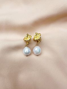 The Dasha Earrings  For pierced ears - order comes with stud earring backs + 14k Gold-plated crinkle earring + Genuine, freshwater baroque pearls ABOUT BAROQUE PEARLS Baroque pearls are some of the most fascinating organic gems available on the jewelry market. Baroque refers to all pearls that aren't perfect spheres. In other words, if it isn't perfectly round, it is considered a baroque pearl. These imperfections result in pearls of varied and irregular shapes and sizes, sometimes with uneven s Baroque Pierced Earrings As Gift, Gold Pearl Drop Plug Earrings As Gift, Baroque Pearl Earrings As A Gift, Single Baroque Earring As A Gift, Gold Clip-on Cluster Earrings As Gift, Gold Clip-on Cluster Earrings For Gift, Gold Cluster Earrings With Pearl Drop For Gift, Gold And Pearl Earrings, Jewelry Market