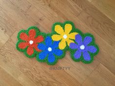 a pair of flower rugs sitting on top of a wooden floor