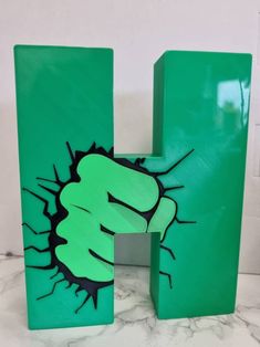 the letter h is painted green and has a fist drawn on it's side