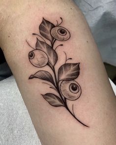 a black and white photo of an olive branch tattoo