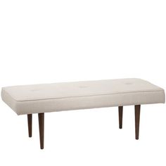 a white bench sitting on top of a wooden frame