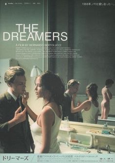 a man and woman standing in front of a mirror with the words the dreamers written on it