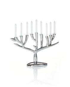 a silver menorah with white candles in it