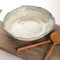 a wooden spoon sitting next to a bowl on top of a table