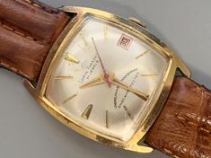 ⭐️⭐️⭐️⭐️⭐️ LORIN PIRADET MENS Vintage Watch, 21 Jewels Wind Up, Sweep Second Hand, Ships Free. Click Item Details to Read More vintage 60s gold color  w/day man hand-wind watch ✅ DIAL: A handsome white dial with golden hands and hour markers. Date window at the three. Sweep Second Hand. Dial is signed: Lorin Piradet, 21 Jewels, Unbreakable Mainspring. Shock Protected.  ✅ CASE:  Gold plated rectangular tonneau case with stainless steel back. Back is signed: Base Metal Bezel, Stainless Steel Back. Golden Hands, Man Hand, Men's Vintage Watch, Watch Dial, Mens Vintage, White Dial, Wristwatch Men, Wrist Watches, Vintage 60s