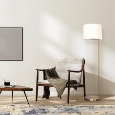 a living room with a couch, chair and coffee table in front of a large poster on the wall