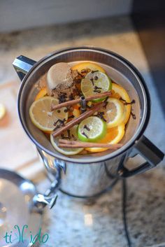 a cup filled with fruit and spices on top of a counter