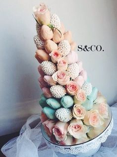 a wedding cake with flowers and pearls on top