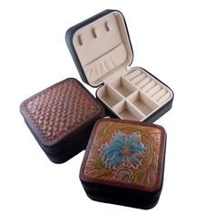 three different types of jewelry cases with designs on them, one opened and the other closed