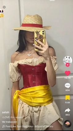 a woman wearing a red and yellow corset while holding a cell phone