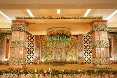 an elaborate stage decorated with flowers and greenery