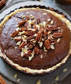 a chocolate pie with pecans on top