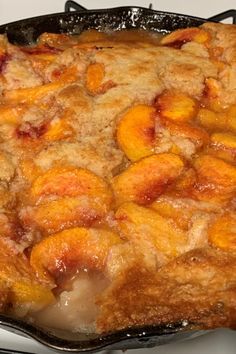 peach cobbler in a cast iron skillet ready to be eaten