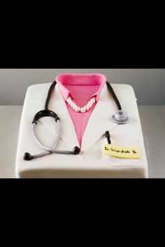 a cake shaped like a doctor's uniform with a stethoscope on it