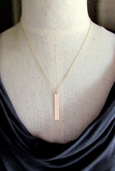 "This gold bar necklace is a long vertical gold filled rectangle pendant.  It is a brushed gold minimalist necklace.  Using a precisely cut gold filled (14K GF has a thick layer of 14 karat gold over a base...won't wear off, discolor like plated gold) bar (1.5\" x .25\"), I filed, sand and polish the piece after brushing the surface for a lovely shimmer.    Select from the drop-down box for your chain.  The choices are available in several lengths including 16\", 18\" or 20\" (on model), with a Gold Bar Necklace With Rectangular Pendant For Everyday, Gold Rectangular Bar Necklace, Minimalist Personalized Rectangular Bar Necklace, Yellow Gold Rectangular Bar Necklace, Dainty Gold Bar Necklace With Rectangular Pendant, Dainty Gold Rectangular Bar Necklace, Minimalist Gold Bar Necklace As Gift, Minimalist Gold Bar Necklace For Gift, Personalized Gold Bar Necklace Minimalist Style