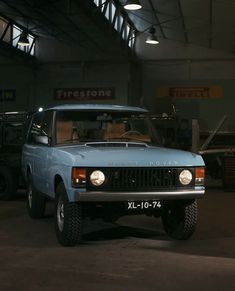 a blue pick up truck parked in a garage