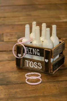 a wooden crate filled with lots of white bottles