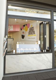 the front window of a restaurant with an ice cream display on it's side