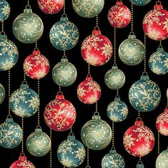 christmas ornaments hanging from chains on a black background