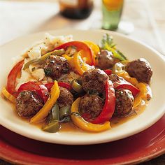 a white plate topped with meat and peppers