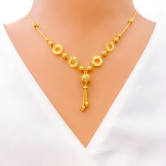 This 22k gold necklace, weighing 9.1 grams, features a trendy design with a dangling orb, polished in a radiant yellow gold finish. The necklace is 17 inches long, with a drop length of 1.25 inches, and includes 1 inch of adjustable links for a perfect fit, secured by an S lock. The singular orb adds a modern touch, making this piece a standout accessory. Ideal for those seeking a blend of contemporary style with the timeless elegance of gold, this necklace is perfect for adding a touch of sophistication to any look, whether for daily wear or special occasions. PRODUCT DETAILS Gold Purity(karat): 22k Gold Weight(grams): 9.1 Item Finish: Yellow Gold Necklace Length: 17" Drop Length: 1.25" Adjustable Links: 1" Links Lock Style: S Lock 22k Gold Necklace, Lock Style, Yellow Gold Necklace, Luxury Life, 22k Gold, Necklace Length, Gold Finish, Contemporary Style, Timeless Elegance