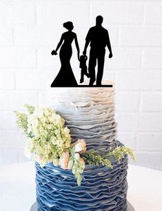 a cake with a silhouette of a man and woman holding hands