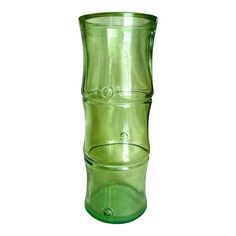 a green glass vase sitting on top of a table