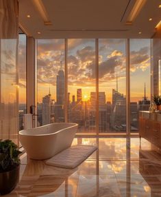 a bathroom with a large bathtub in front of a window overlooking the city at sunset