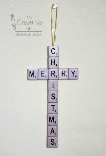 a cross made out of scrabble tiles with the words merry christmas on it