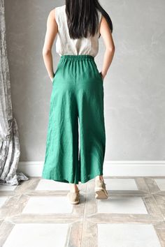 "ELISE wide linen pants are made from 100% pure linen, making them breathable, lightweight, and perfect for warm summer days. The loose cut and relaxed fit ensure maximum comfort. These palazzo linen pants have 2 deep functional side pockets that provide a convenient place to store your phone or some small items, while the elastic waistband allows for an adjustable and comfortable fit. Each piece in our linen shop is handcrafted with care, ensuring a unique and personal touch. The beautiful and Casual Green Linen Bottoms, Summer Linen Pants With Pockets, Wide Leg Ramie Bottoms With Pockets, Linen Bottoms With Elastic Waistband And Loose Fit, Summer Linen Ankle-length Bottoms, Summer Linen Ankle-length Pants, Spring Linen Pants With Pockets, Green Linen Wide Leg Pants With Elastic Waistband, Flax Linen Pants With Elastic Waistband