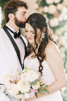 a bride and groom pose for a wedding photo