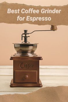 an espresso machine sitting on top of a wooden table next to a sign that says best coffee grinder for espresso