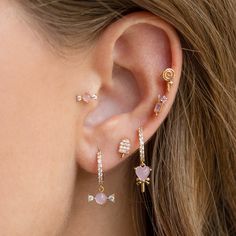 a close up of a person with ear piercings on their ears and behind the ear