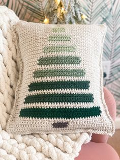 a crocheted christmas tree pillow on a couch