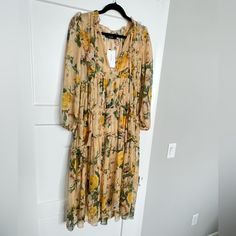 Sheer Dress With Matching Slip. Horizontal Ruffles. Deep V Neck With Tie. Flowy Skirt, Length Between Midi And Maxi. Creamy, Yellow/Tan Color With Yellow/Gold/Mustard And White Flowers And Green Leaves. Reminds Me Of Sunflowers Yellow Long Sleeve Midi Dress With Floral Print, Yellow Midi Dress For Fall Brunch, Spring Mustard Midi Dress With Floral Print, Spring Mustard Floral Print Midi Dress, Mustard Floral Print Midi Dress For Spring, Yellow Floral Print Midi Dress For Fall, Yellow V-neck Midi Dress For Daywear, Yellow Long Sleeve Midi Dress For Brunch, Mustard Floral Print Maxi Dress For Spring