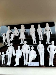 a group of white figurines sitting on top of a shelf