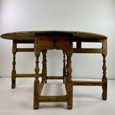 an old wooden table with two drawers on it