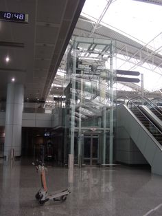 a scooter is parked in front of an escalator