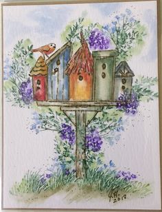 a watercolor painting of some bird houses