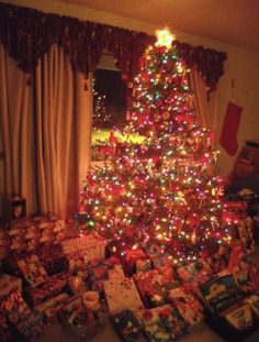 a christmas tree with many presents under it