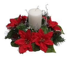 a white candle surrounded by poinsettia and greenery