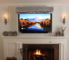 a flat screen tv mounted above a fireplace